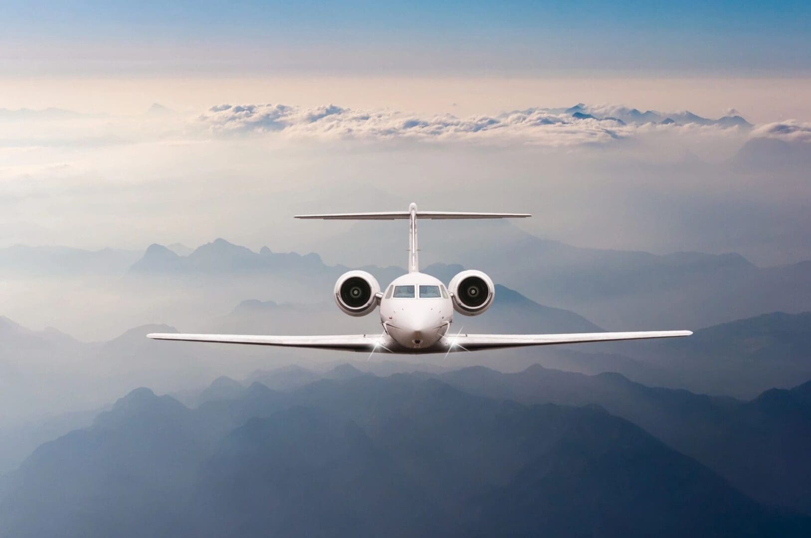 A plane flying in the sky with clouds overhead.